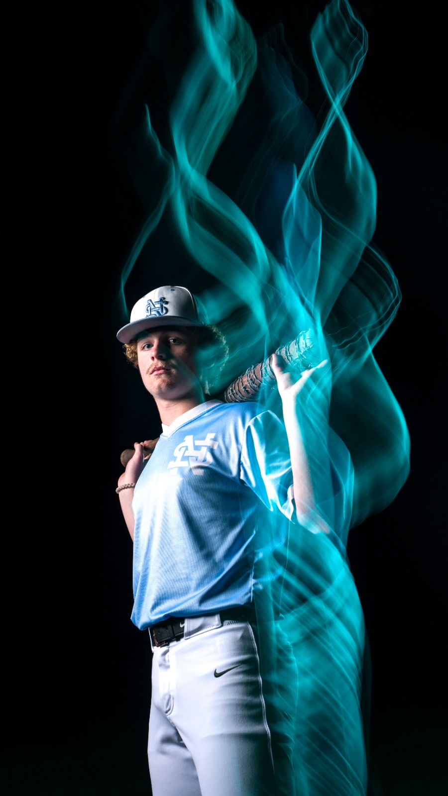 Baseball senior with teal light trails